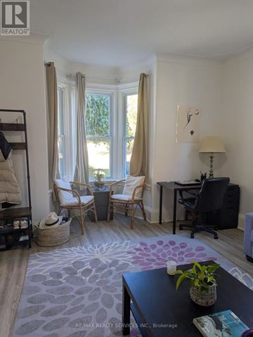 Cambridge apartment for rent - A living room with a black table and a white wall.
