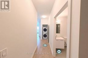 Kitchener condo for rent - A hallway with a washing machine and dryer in it.