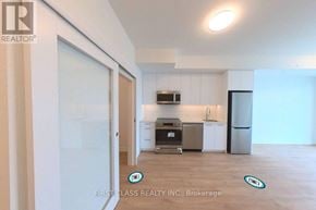 Kitchener condo for rent - A kitchen area with a refrigerator, oven, and sink.