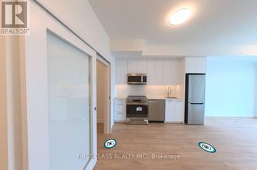 Kitchener condo for rent - A kitchen area with a refrigerator, oven, and sink.