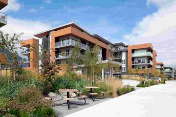 Squamish apartment for rent - A modern building with a garden in front.
