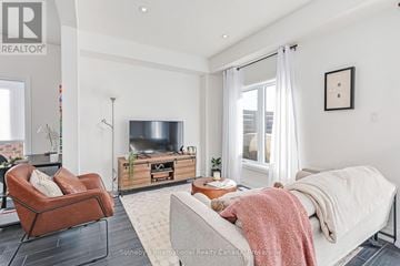 Collingwood apartment for rent - A modern living room with a large couch and a television.
