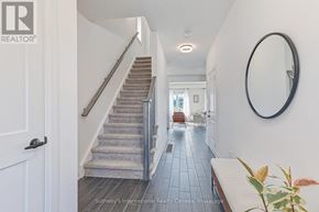 Collingwood apartment for rent - A hallway with a staircase and a mirror on the wall.