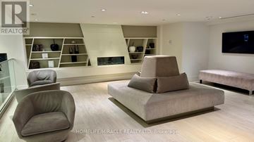 Vaughan (Concord) condo for rent - A living room with a grey sofa and a glass table.