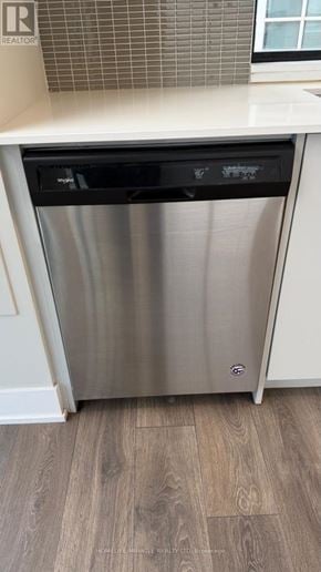 Vaughan (Concord) condo for rent - A dishwasher is in a kitchen with a white counter.