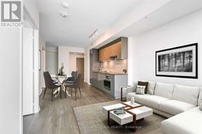 Toronto (Mount Pleasant West) condo for rent - A modern living room with a dining area and a kitchen in the background.