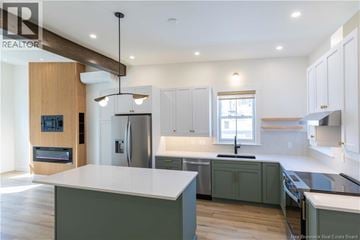 Saint John apartment for rent - A modern kitchen with a wooden counter and white cabinets.