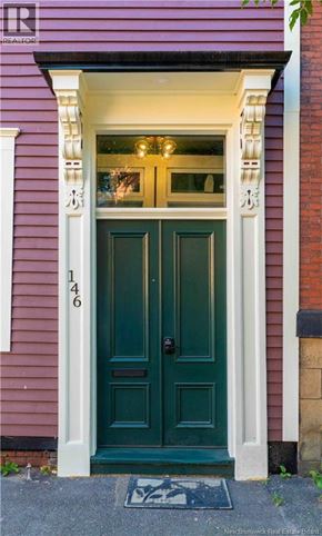 Saint John apartment for rent - A purple house with a green door and a number 146 on it.