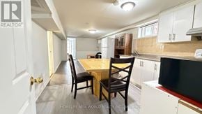 Toronto (Hillcrest Village) apartment for rent - A kitchen with a table and chairs in the middle of the room.