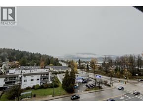 Port Moody apartment for rent - A view of a street with cars and buildings from a window.