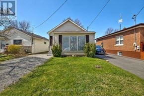 St. Catharines (Western Hill) apartment for rent - A house with a grey roof and a small front yard.