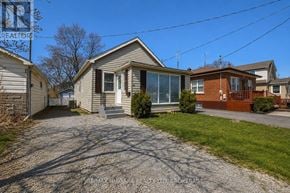 St. Catharines (Western Hill) apartment for rent - A house with a gravel driveway in front of it.
