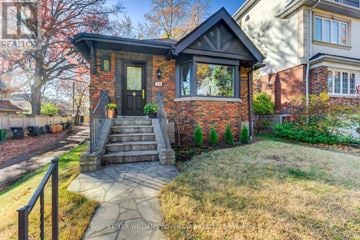 Toronto (The Beaches) apartment for rent - A house with a brick facade and a black door is for sale.