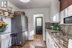 Toronto (The Beaches) apartment for rent - A kitchen with a refrigerator, a sink, and a counter.