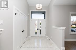 Port Colborne (Sugarloaf) apartment for rent - A hallway with a white door and a window with a view of a building outside.