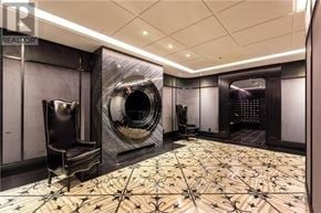 Toronto (Waterfront Communities) condo for rent - A room with a black chair and a black and white tiled floor.