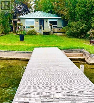 Barrie (South Shore) apartment for rent - A dock leads to a house with a green roof.