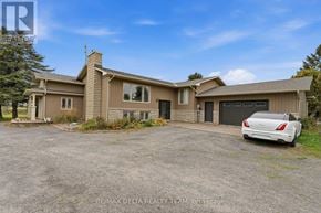 Ottawa apartment for rent - A house with a car parked in front of it.