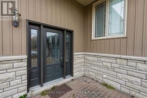 Ottawa apartment for rent - A house entrance with a black door and a window above it.