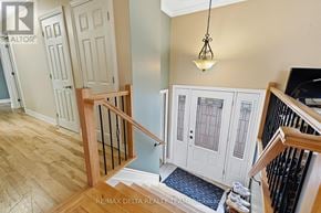 Ottawa apartment for rent - A staircase with a wooden banister and a black metal railing.