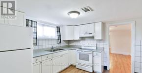 Oshawa (Central) apartment for rent - A white kitchen with a refrigerator and cabinets.