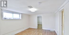 Oshawa (Central) apartment for rent - A room with wooden flooring and white walls, with a window on the left side.