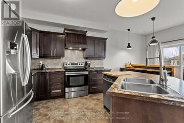 Clarence-Rockland apartment for rent - A modern kitchen with dark brown cabinets and stainless steel appliances.