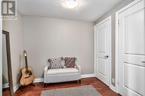 Mississauga (Clarkson) condo for rent - A room with a white couch and a guitar.