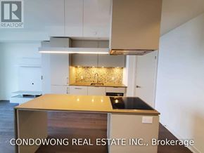 Toronto (Waterfront Communities) condo for rent - A kitchen with a wooden countertop and a stove top oven.