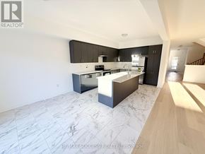 Barrie apartment for rent - A modern kitchen with a marble floor and wooden cabinets.