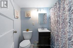 Toronto (Dovercourt-Wallace Emerson-Junction) townhouse for rent - A small bathroom with a toilet, sink, and shower curtain.