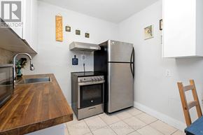 Toronto (Dovercourt-Wallace Emerson-Junction) townhouse for rent - A kitchen with a stainless steel refrigerator, oven, and sink.