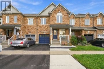 Milton (Be Beaty) townhouse for rent - A brick house with a car parked in front and another car parked in the driveway.