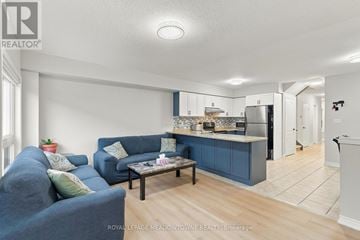 Milton (Be Beaty) townhouse for rent - A living room with a blue couch and a coffee table.