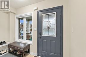 Milton (Be Beaty) townhouse for rent - A grey door with a glass window is in front of a white wall.