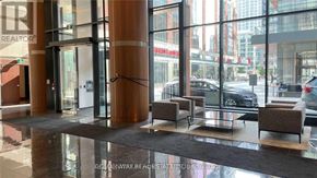 Toronto (Waterfront Communities) condo for rent - A glass door entrance to a building with a sign that says REALTOR.