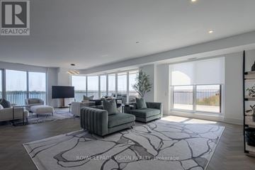 Toronto (Waterfront Communities) condo for rent - A living room with a grey couch and a large window.