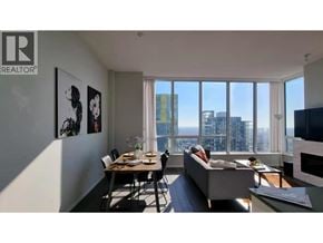 Burnaby apartment for rent - A living room with a dining table and chairs, a couch, and a television.