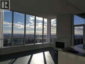 Burnaby apartment for rent - A sunny day with a view of the city from a large window.