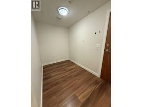 Richmond apartment for rent - A small room with wooden floors and a door on the right.