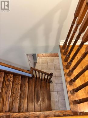 Mississauga (Meadowvale Village) apartment for rent - A wooden staircase with a metal handrail.