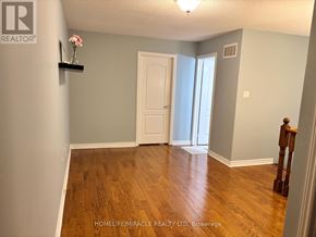 Mississauga (Meadowvale Village) apartment for rent - A room with wooden floors and a white door.