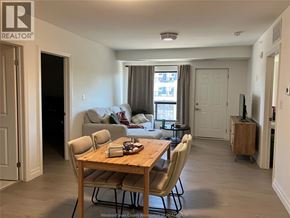 Windsor condo for rent - A living room with a dining table and chairs.