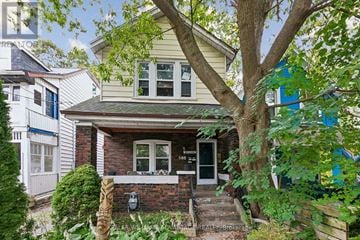 Toronto (East End-Danforth) apartment for rent - A house with a front yard and a tree in front of it.