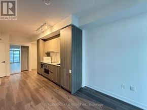 Vaughan (Vaughan Corporate Centre) condo for rent - A kitchen area with a wooden floor and white walls.
