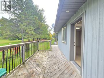 East Gwillimbury apartment for rent - A deck with a railing and a door leading to a house.