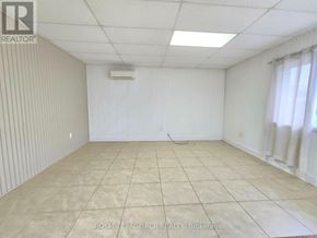 East Gwillimbury apartment for rent - A white room with a tiled floor and a window with curtains.