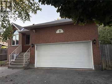 Hamilton apartment for rent - A red brick house with a white garage door and number 3 on the wall.