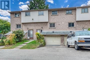 Hamilton (Beasley) townhouse for rent - A white van is parked in front of a two-story house.