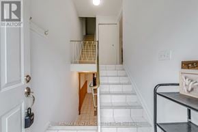 Hamilton (Beasley) townhouse for rent - A hallway with a staircase and a table with a box on it.